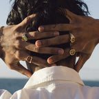Men’s signet rings worn on hand with bracelets