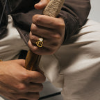 Men’s signet ring worn on hand with bracelets