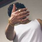 Men’s signet ring worn on hand with bracelets